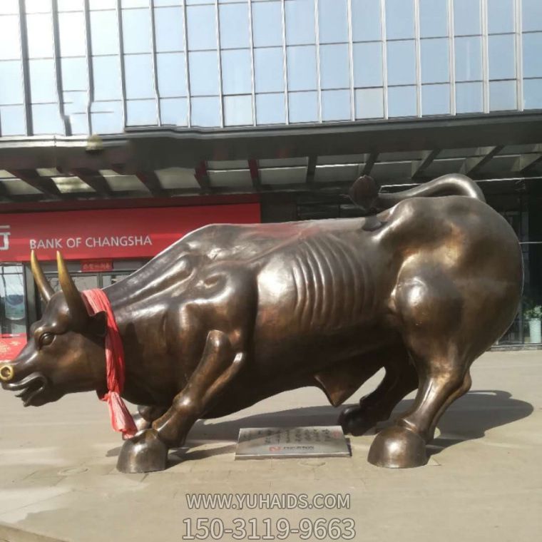 廣場上擺放的一只半蹲的玻璃鋼創意華爾街牛雕塑